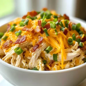 - 2 lbs (900g) boneless, skinless chicken thighs - 8 oz (225g) cream cheese, softened - 1 cup (240ml) chicken broth - 1 packet ranch seasoning mix - 1 cup (120g) shredded cheddar cheese - 6 slices of cooked bacon, crumbled - 2 green onions, sliced (for garnish) - Salt and pepper to taste The key to a great Keto Crack Chicken lies in the quality of these ingredients. I love using boneless chicken thighs because they stay juicy and tender. Cream cheese adds a rich, creamy texture. Chicken broth enhances the flavor of the dish. The ranch seasoning mix brings a fantastic taste that pairs well with chicken. Shredded cheddar cheese melts beautifully and adds a savory touch. Crumbled bacon gives a crispy bite, making the dish even more tempting. Finally, green onions add a fresh crunch and bright color to the plate. - Alternatives for cream cheese: If you need a dairy-free option, try using coconut cream. It offers a similar texture without dairy. - Low-carb options for chicken broth: You can use homemade broth or bone broth. These options are rich in nutrients and low in carbs. - Substituting ranch seasoning: If you want a different flavor, use taco seasoning or Italian herbs. Both can add a unique twist to your dish. These substitutions can help you customize the recipe while keeping it delicious and keto-friendly. {{ingredient_image_1}} To start, you need to layer the chicken in your slow cooker. I like to place the boneless, skinless chicken thighs at the bottom. This helps them cook evenly and soak up all the flavors. Using boneless thighs is key. They stay juicy and tender, making the final dish melt in your mouth. Next, let’s make the sauce. In a medium bowl, blend the softened cream cheese, chicken broth, and ranch seasoning mix. I recommend using a hand mixer or whisking vigorously until the mix is smooth. A smooth sauce means no lumps and better taste. Now, it’s time to cook. Cover the slow cooker and set it to low for 6-7 hours or high for 3-4 hours. The chicken is done when it easily shreds with a fork. Keep an eye on it so you don’t overcook. Once the chicken is tender, shred it right in the slow cooker. Use two forks to pull it apart. Mix it well with the sauce. Then, stir in the shredded cheddar cheese and crumbled bacon. Let it blend until the cheese melts. Season with salt and pepper to taste. Finally, serve warm and top with sliced green onions for a fresh touch. To ensure tender chicken, use boneless, skinless chicken thighs. They stay moist during cooking. Season the chicken lightly with salt and pepper before adding the sauce. This helps boost flavor. If you find your slow cooker cooks hot, check the chicken sooner. Cooking times vary with different models. For slow cookers that run hotter, reduce cooking time by one hour. Keto Crack Chicken pairs well with simple side dishes. I suggest serving it with steamed broccoli or a fresh salad. These sides add crunch and color to your plate. For a fun twist, consider cauliflower rice. It gives a nice texture and keeps it low-carb. Garnishing with sliced green onions adds a fresh look and taste. You can also sprinkle extra bacon bits on top for a great finish. Prepping ingredients in advance makes cooking easier. You can mix the sauce the night before and store it in the fridge. Just pour it over the chicken in the morning. If you're short on time, shred the chicken ahead of time too. To reheat, use a slow cooker or microwave. Add a splash of chicken broth to keep it moist. This way, your Keto Crack Chicken stays flavorful and delicious! Pro Tips Use Thighs for Juiciness: Boneless, skinless chicken thighs are ideal for this recipe since they remain juicy and tender during slow cooking, enhancing the overall flavor. Mix Ingredients Well: Ensure that the cream cheese is fully softened before mixing with the broth and ranch seasoning for a smooth and creamy sauce. Shred Chicken While Hot: Shredding the chicken while it's still hot in the slow cooker allows it to absorb more of the sauce, making it extra flavorful. Garnish for Color: Adding sliced green onions not only adds a pop of color but also a fresh flavor that balances the richness of the dish. {{image_2}} You can change the taste of Keto Crack Chicken with a few easy tweaks. Try adding spices like garlic powder, onion powder, or smoked paprika. These spices add depth and warmth. Fresh herbs, such as parsley or dill, brighten the dish too. If you love heat, add diced jalapeños. They give a kick that pairs well with the creamy sauce. For a low-carb base, consider using cauliflower rice. It absorbs the flavors well and adds a nice texture. To make a stuffed pepper dish, hollow out bell peppers. Fill them with the cooked chicken mix. Bake until the peppers are tender. This adds a fun twist and makes your meal more colorful. If you need a dairy-free option, swap the cream cheese for a nut-based cream. You can use cashew cream or coconut cream. These alternatives keep the dish creamy without dairy. For a gluten-free meal, check your ranch seasoning mix. Many brands contain gluten, so choose one that is labeled gluten-free. This way, you enjoy all the flavors without worry. To keep your Keto Crack Chicken fresh, place it in the fridge right away. Use airtight containers to prevent moisture loss. This helps maintain its taste and texture. Make sure to let it cool before sealing it. This avoids condensation inside the container. If you want to save some for later, freezing works well. Divide the Keto Crack Chicken into smaller portions. Place each portion in a freezer bag or container. Label it with the date. When you are ready to eat, thaw it overnight in the fridge. To reheat, warm it in a pan over medium heat or use a microwave. In the fridge, Keto Crack Chicken lasts about 3 to 4 days. Always check for signs of spoilage. If it smells bad or looks off, throw it away. Trust your senses; they are your best guide for food safety. Keto Crack Chicken is a creamy, savory dish made with chicken. It has gained a huge following due to its rich flavor and easy prep. The key is the mix of ranch seasoning, cream cheese, and cheese. This dish is perfect for keto diets, as it is low in carbs and high in fat. It cooks in a slow cooker, making it a hassle-free meal option. Yes, you can use chicken breast. However, chicken thighs provide more flavor and moisture. Thighs stay tender during cooking while breasts can dry out. If you prefer breast meat, consider adding extra broth to keep it juicy. Absolutely! This recipe is great for meal prep. You can portion it into containers for easy lunches or dinners. It keeps well in the fridge for up to four days. Reheat it gently in the microwave or on the stove. You can adapt Keto Crack Chicken for other diets. For paleo, swap ranch seasoning for herbs and spices. For Whole30, use compliant cream cheese or a nut-based alternative. These small changes can keep the dish aligned with your dietary needs. Keto Crack Chicken is easy to make and full of flavor. You layer chicken, cream cheese, and seasonings in a slow cooker. Remember to use boneless thighs for the best texture. For variations, try new spices or swap in low-carb sides. This dish is meal prep friendly and stores well. Follow these tips, and you’ll always have a tasty meal ready. Enjoy experimenting with this recipe and making it your own!