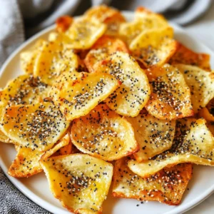 - 4 everything bagels, sliced thinly - 2 tablespoons olive oil - 1 teaspoon garlic powder - 1 teaspoon onion powder - 1 teaspoon sesame seeds - 1 teaspoon poppy seeds - 1 teaspoon flaky sea salt - 1 teaspoon dried dill (optional) - You can add dried herbs like oregano or thyme. - A pinch of paprika gives a nice smoky taste. - Try adding some crushed red pepper for a spicy kick. - Swap olive oil for avocado oil or melted butter. - Use bagels with different flavors, like onion or poppy seed. - If you don’t have garlic powder, use fresh garlic. These ingredients will help you make the most tasty bagel chips. Feel free to mix and match to fit your taste! {{ingredient_image_1}} To start, grab four everything bagels. Slice them thinly, about 1/8 inch thick. Thin slices help the chips get nice and crunchy. Next, take a large mixing bowl. Add 2 tablespoons of olive oil, 1 teaspoon of garlic powder, and 1 teaspoon of onion powder. Also, include 1 teaspoon of sesame seeds and 1 teaspoon of poppy seeds. Then, toss in 1 teaspoon of flaky sea salt and 1 teaspoon of dried dill if you want extra flavor. Mix everything well to create a tasty oil blend. Add the bagel slices to the bowl. Gently toss them until every slice gets a good coat of the oil mix. This step is key for flavor and crispiness. Now, preheat your air fryer. Set it to 350°F (180°C) and let it warm up for 3-5 minutes. Once it's hot, arrange the bagel slices in a single layer in the air fryer basket. Depending on your air fryer size, you might need to do this in batches. Air fry the bagel slices for 5-7 minutes. Flip them halfway through for even cooking. Keep an eye on them, as they can burn fast. You want them golden brown and crispy. To check if the chips are done, look for a golden color. They should feel hard and crisp when you touch them. If they seem soft, air fry them a bit longer. Once cooked, take them out and let them cool on a wire rack. This helps keep them crunchy. Repeat this process with any leftover bagel slices. Enjoy your homemade everything bagel chips! To make your bagel chips super crispy, slice them very thin. Aim for about 1/8 inch thickness. This helps them fry evenly. If you slice them too thick, they may end up chewy instead of crunchy. Preheat your air fryer to 350°F (180°C) for a few minutes before cooking. This step gives your chips a nice, even cook. Use a mixing bowl to combine the olive oil and spices. This allows you to coat the bagel slices evenly. Toss the slices gently in the oil blend. Make sure every piece gets some oil, garlic powder, and onion powder. You want full flavor in every bite. If you skip this step, your chips may taste bland. If your bagel chips burn quickly, check the air fryer temperature. It may be too hot. Keep an eye on them while they cook. Flipping the chips halfway through helps them cook evenly. If they come out soggy, they might need a bit more time in the air fryer. Always let them cool on a wire rack to keep that crunch. Pro Tips Slice Evenly: Make sure to slice the bagels evenly at about 1/8 inch thickness. This ensures they cook uniformly and achieve the perfect crispiness. Keep an Eye on Them: Bagel chips can burn quickly in the air fryer. Always check them around the halfway point and adjust cooking time as needed for your specific air fryer model. Experiment with Flavors: Feel free to customize the seasoning mix! Add your favorite spices or herbs to create different flavor profiles according to your taste preferences. Store Properly: Once cooled, store any leftover bagel chips in an airtight container to maintain their crispiness. They can last for several days if stored correctly. {{image_2}} You can change the bagel flavor to suit your taste. Try using onion bagels or sesame bagels. These options will add a unique twist to your chips. You can even experiment with cheese bagels for a rich taste. Just make sure to slice them thinly, and follow the same steps. This way, you’ll still get that perfect crunch. The seasoning blends can make your bagel chips special. You can use ranch seasoning for a zesty kick. Cajun seasoning adds a bit of spice, while a blend of Italian herbs gives a fresh flavor. Just mix your chosen spices into the olive oil before coating the bagels. This small change can lead to big taste differences. Bagel chips pair well with many dips and spreads. Cream cheese is a classic choice. You can also try hummus or guacamole for a fun twist. A spinach dip will make for a tasty party snack. Just remember to serve your chips in a nice bowl to impress your guests. You can even create a dip bar with a few options for everyone to enjoy. To store leftover bagel chips, let them cool completely first. Place them in an airtight container. This keeps them crispy. You can also use a resealable plastic bag. Make sure to squeeze out any air before sealing. When you want to enjoy your leftover bagel chips, heat your air fryer to 350°F (180°C). Place the chips in a single layer in the basket. Heat for about 2-3 minutes. This will restore their crunch. Keep an eye on them to avoid burning. To maintain freshness, store your bagel chips in a cool, dry place. Avoid humidity, as it can make them soggy. If you can, eat them within a week for the best taste. For longer storage, you can freeze them. Just remember to let them thaw before reheating. Yes, you can make bagel chips in a conventional oven. Preheat your oven to 350°F (180°C). Arrange the thin bagel slices on a baking sheet in a single layer. Brush them with the oil and spice mix. Bake for about 10-15 minutes. Flip them halfway through to ensure they crisp evenly. Keep an eye on them to avoid burning. Bagel chips can last for about a week if stored correctly. Place them in an airtight container at room temperature. If you want them to last longer, you can freeze them. Just make sure they are fully cooled before freezing. To enjoy, simply thaw and re-crisp them in the air fryer. Absolutely! Stale bagels work great for making chips. In fact, they can turn out even crispier than fresh ones. Just slice them thin and follow the same steps. The oil and spices will add flavor and help them become crunchy. It's a perfect way to reduce food waste too! In this post, we explored how to make delicious bagel chips. We covered essential ingredients, step-by-step instructions, and tips for perfect crispiness. I shared ways to add flavors and serve them with dips. Remember, using fresh bagels or even stale ones can enhance your snacks. Enjoy creating your own bagel chips at home and experiment with different flavors. Happy cooking!