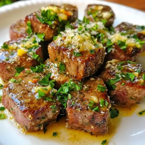 To make Garlic Butter Steak Bites with Parmesan, you will need the following ingredients: - 1 pound sirloin steak, cut into bite-sized pieces - 4 tablespoons butter - 4 cloves garlic, minced - 1 tablespoon fresh parsley, chopped - ½ cup grated Parmesan cheese - Salt and pepper to taste - ½ teaspoon red pepper flakes (optional) - 1 tablespoon olive oil Each ingredient plays a key role in creating the dish's rich flavor. The sirloin steak provides a tender, juicy base. Butter and garlic work together to create a creamy sauce that coats the steak perfectly. Fresh parsley adds color and a hint of freshness. Grated Parmesan cheese gives that delicious, savory finish. Salt and pepper enhance all the flavors, while red pepper flakes add a touch of heat if you like spice. Olive oil helps with cooking and adds flavor too. Gather these ingredients before you start cooking. It makes the process smooth and fun. Enjoy the cooking adventure! {{ingredient_image_1}} Start by patting the steak pieces dry with a paper towel. This step is key. Moisture will hinder that perfect sear we want. Next, season the steak with salt and pepper. Use enough to flavor every bite. This seasoning adds depth to the dish. Now, heat olive oil in a large skillet over medium-high heat. Wait until the oil shimmers. This shows it’s hot enough. Add the steak pieces in a single layer. Don’t overcrowd the pan; this ensures a good sear. Sear each side for 2-3 minutes. Look for a rich, golden brown color on the edges. When done, remove the steak bites and set them aside. Lower the heat to medium. In the same skillet, add butter and let it melt. Once melted, toss in the minced garlic. Cook it for about 30 seconds. You want the garlic fragrant but not burnt. Burnt garlic can taste bitter. Now, return the steak bites to the skillet. Add the chopped parsley and optional red pepper flakes. Toss everything together well. The goal is to coat the steak in that rich garlic butter. The heat will help infuse all those flavors. Sprinkle the grated Parmesan cheese over the steak. Toss once more to mix. The cheese should melt slightly and cling to the steak. This adds a wonderful creaminess to each bite. Taste the steak bites and adjust the seasoning if needed. Serve them hot on a plate. For a pretty touch, garnish with extra parsley. This adds color and freshness. Enjoy your delicious Garlic Butter Steak Bites with Parmesan! For this dish, I recommend using sirloin steak. Sirloin is tender and flavorful. You can also try ribeye or tenderloin. These cuts have great taste and cook well in bite-sized pieces. Look for steaks with some marbling. This fat adds moisture and richness to your bites. To get that nice crust, avoid overcrowding the skillet. Cook the steak bites in batches. This helps the meat brown evenly. If you add too many pieces, they will steam instead of sear. Use a large skillet and heat the oil until it shimmers before adding the steak. If you need a change, you can swap butter for olive oil or ghee. For cheese alternatives, try Asiago or Pecorino Romano. You can also use herbs like thyme or oregano instead of parsley. These changes can give a new twist to the dish. If you want to manage the heat from red pepper flakes, start with a small pinch. You can always add more if you like it spicier. If you want a milder flavor, skip the red pepper flakes altogether. Remember, you can customize this dish to fit your taste! Pro Tips Rest the Steak: Allow the steak to rest for a few minutes after cooking. This helps the juices redistribute, ensuring a tender bite. Use High Heat: Searing the steak at a high temperature creates a beautiful crust. Make sure your skillet is hot before adding the steak. Fresh Garlic: Always opt for fresh garlic instead of pre-minced. It offers a more robust flavor and aroma in the dish. Cheese Variation: For a different flavor profile, try using Pecorino Romano or a blend of cheeses for extra richness. {{image_2}} You can make Garlic Butter Steak Bites even better with veggies. Try adding bell peppers, mushrooms, or zucchini. Slice them into bite-sized pieces. Cook them in the skillet before adding the steak. This way, they soak up the garlic butter flavor. You can also add spinach right at the end for a fresh touch. This adds color and nutrition to your meal. While Parmesan is classic, you can switch it up. Try using feta for a tangy kick. Or go for mozzarella for a creamy texture. Crumbled blue cheese can add a bold flavor. If you like something stronger, aged cheddar is a great choice. Mix and match these cheeses for fun and tasty bites. Fresh herbs can change the taste of your dish. If you don’t have parsley, use thyme or rosemary instead. Both add a lovely aroma and flavor. Basil is another great option, giving a hint of sweetness. Cilantro works well if you’re in the mood for a fresh twist. Experiment with different herbs to find your favorite combination! To store leftovers, place steak bites in an airtight container. Make sure they cool first. Keep them in the fridge for up to three days. When reheating, use a skillet over low heat to warm them gently. This keeps them tender and juicy. You can freeze these steak bites too. First, let them cool completely. Then, place them in a freezer-safe bag. Try to remove as much air as possible. They will last up to three months in the freezer. To reheat, thaw them overnight in the fridge. Then, warm them in a skillet to get that nice sear back. These steak bites stay fresh for about three days in the fridge. If frozen, they maintain quality for up to three months. Always check for any off smells or changes in color before eating. Yes, you can use other cuts. Good options include flank steak, ribeye, or tenderloin. Each type brings a unique flavor and texture. Flank steak is leaner, while ribeye is rich and juicy. Tenderloin offers a melt-in-your-mouth feel. Just remember to adjust cooking times based on thickness. You can prep some parts ahead of time. Cut and season the steak pieces a few hours early. Store them in the fridge for better flavor. You can also mix the garlic butter ahead of time. Just warm it up when you’re ready to cook. Many sides go well with these steak bites. Here are some ideas: - Roasted vegetables - Garlic mashed potatoes - Steamed broccoli - A fresh salad These sides add balance and enhance your meal. To check steak doneness, use a meat thermometer. Aim for 130°F for medium-rare and 145°F for medium. If you don’t have a thermometer, you can press the steak. Firmness indicates doneness. The more it gives, the rarer it is. In this post, we covered how to make delicious Garlic Butter Steak Bites. You learned about the key ingredients, like sirloin and garlic butter, and step-by-step cooking methods. I shared tips for choosing the best steak and how to modify the recipe with vegetables or different cheeses. Finally, we discussed storage and answered common questions. With these insights, you can create a tasty meal that impresses. Enjoy your cooking journey and the delicious results!