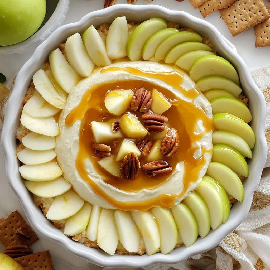 - 8 oz cream cheese, softened - ½ cup powdered sugar - 1 tsp vanilla extract - 1 cup sour cream - 1 cup finely chopped apples - ½ cup caramel sauce (plus extra for drizzling) - ¼ cup chopped pecans or walnuts (optional) To create this tasty dip, you need just a few simple ingredients. First, grab 8 ounces of cream cheese. Make sure it is softened for easy mixing. Next, have ½ cup of powdered sugar ready. This gives the dip its sweet taste. You will also need 1 teaspoon of vanilla extract for flavor. Next, get 1 cup of sour cream. This adds creaminess to the dip. You will also need 1 cup of finely chopped apples. I like using Granny Smith or Honeycrisp apples for their tartness. Then, grab ½ cup of caramel sauce. Save some for drizzling on top later. If you want a crunch, add ¼ cup of chopped pecans or walnuts. This is optional but tasty. - Apple slices - Graham crackers For dipping, I suggest using fresh apple slices. They pair perfectly with the sweet dip. Graham crackers are also a great option. They add a nice crunch and sweetness. These choices make the dip even more fun to eat! {{ingredient_image_1}} To start our delicious dip, grab a large bowl. First, beat 8 oz of softened cream cheese with a hand mixer. Mix until it’s smooth and creamy. This step is key for a great texture. Next, add in ½ cup of powdered sugar and 1 tsp of vanilla extract. Keep mixing until everything is well combined. Now it’s time to make the dip even tastier. Add 1 cup of sour cream to your cream cheese mix. Blend until it’s fluffy and smooth. This will give the dip a nice tang. Gently fold in 1 cup of finely chopped apples. I love using Granny Smith or Honeycrisp for their crunch. Then, add ½ cup of caramel sauce. This makes the dip sweet and rich. If you want a crunch, fold in ¼ cup of chopped pecans or walnuts. Transfer your dip to a serving bowl. Create a small well in the center for the caramel. Drizzle more caramel sauce over the top. Let it cascade into the well. This looks great and adds flavor. Chill the dip in the fridge for at least 30 minutes before serving. This step helps all the flavors come together. Serve with apple slices and graham crackers for dipping. Enjoy your sweet treat! - Alternatives for cream cheese: You can use Greek yogurt or mascarpone for a lighter dip. Both give a smooth texture. - Different types of apples: Granny Smith apples bring tartness, while Honeycrisp adds sweetness. Try Fuji for a juicy bite too. - How to present the dip attractively: Use a clear bowl to show off the layers. Add a drizzle of caramel on top for a sweet finish. - Best occasions for serving: This dip fits well at parties, fall gatherings, or game days. It’s a crowd-pleaser for any sweet tooth. - Adding spices like cinnamon: A dash of cinnamon adds warmth and depth to each bite. It pairs great with apples and caramel. - Using flavored caramel sauces: Try salted caramel for a sweet and salty twist. Chocolate caramel also adds a rich flavor that delights. Pro Tips Choose the Right Apples: Use a mix of tart and sweet apples like Granny Smith and Honeycrisp for a balanced flavor in your dip. Make it Ahead: Prepare the dip a few hours in advance to allow the flavors to meld together, enhancing the overall taste. Garnish for Presentation: Top the dip with additional chopped nuts and a sprinkle of cinnamon for an attractive finish. Vary Your Dippers: In addition to apple slices and graham crackers, consider pretzel sticks or vanilla wafers for a fun twist. {{image_2}} You can add cocoa powder or chocolate chips to this dip. This gives it a rich, sweet twist. Start by mixing in 2 tablespoons of cocoa powder when you add the powdered sugar. If you prefer chocolate chips, fold in ½ cup of mini chocolate chips with the apples. The chocolate pairs well with the caramel and cream cheese. To make it nutty, try using different nuts or nut butters. Chopped almonds or hazelnuts add a great crunch. You can also swirl in 2 tablespoons of your favorite nut butter, like peanut or almond butter, for a creamy texture. Just mix it in before you fold in the apples. This adds flavor and a delightful texture. For a healthier option, use reduced-fat cream cheese and sugar substitutes. You can swap the powdered sugar for a sugar alternative like Stevia or erythritol. This way, you cut down on calories while keeping the taste. Use 8 oz of reduced-fat cream cheese to keep it creamy. Your friends and family will enjoy it just as much! Caramel apple cheesecake dip lasts about 3 to 5 days in the fridge. Store it in an airtight container to keep it fresh. Always check for any changes in smell or texture before enjoying it again. Yes, you can freeze this dip! To freeze, place it in a freezer-safe container. Make sure to leave some space at the top for expansion. It can last up to 2 months in the freezer. When ready to eat, thaw it in the fridge overnight. To restore the dip's creamy texture, gently reheat it in the microwave. Use low power and stir it every 15 seconds until warm. Avoid overheating, as this can make it grainy. Enjoy it warm with your favorite dippers! To thicken the dip, you can use a few simple tips: - Add more cream cheese. Increase the amount of cream cheese by 2 oz. - Use less sour cream. Cut the sour cream by a quarter cup. - Incorporate more powdered sugar. Add an extra tablespoon or two for added thickness. These changes will give you a creamier and denser texture. Remember to mix well after each addition. Yes, you can prepare this dip ahead of time! Here’s how: - Mix the ingredients as directed. Follow all the steps until chilling. - Store in an airtight container. Keep it in the fridge for up to 24 hours. - Add caramel topping before serving. Drizzle the caramel just before you serve it. This method allows the flavors to blend nicely. If you want to change up your dippers, consider these options: - Apple slices. They pair perfectly with the dip. - Pretzel sticks. They add a nice crunch and saltiness. - Shortbread cookies. These provide a sweet and buttery flavor. - Vanilla wafers. They are light and add a fun twist. These alternatives can make your dip experience even more exciting! This blog post covered how to make a tasty Caramel Apple Cheesecake Dip. We discussed the main ingredients, including cream cheese, chopped apples, and caramel sauce. I shared step-by-step instructions for making it and provided tips for serving and customizing. You learned about variations and storage tips to keep the dip fresh. In conclusion, this dip is simple to make and perfect for sharing. Try it at your next gathering, and impress your friends with this fun treat!